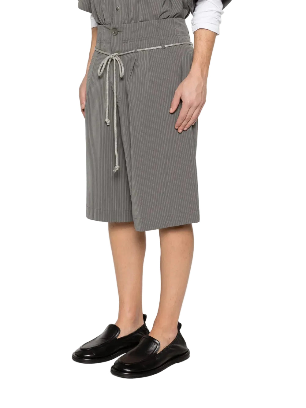 Person wearing a gray skirt with a white background