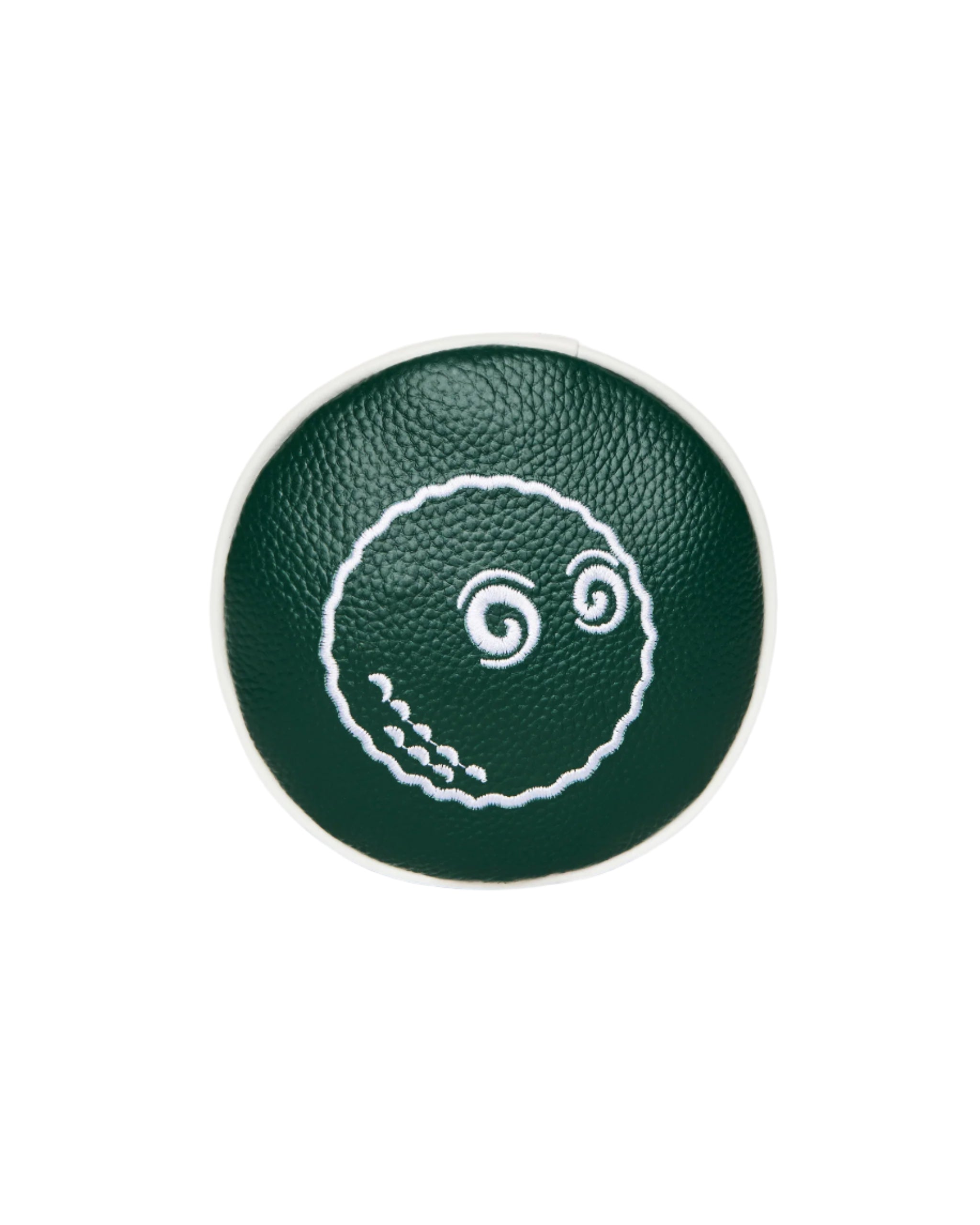 Green circular object with a white design on a white background