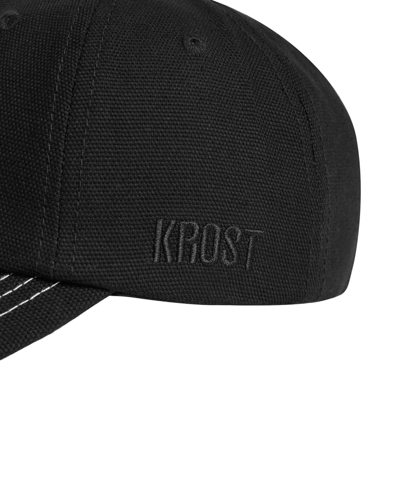 Black cap with 'KROST' branding on a white background