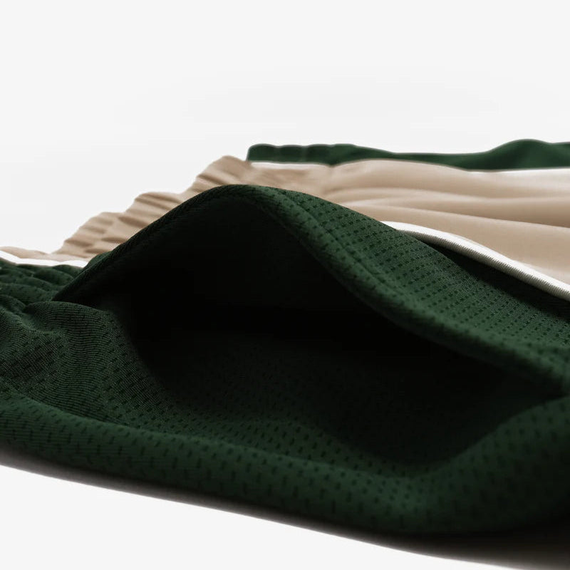 Close-up of green fabric with a textured pattern on a white background