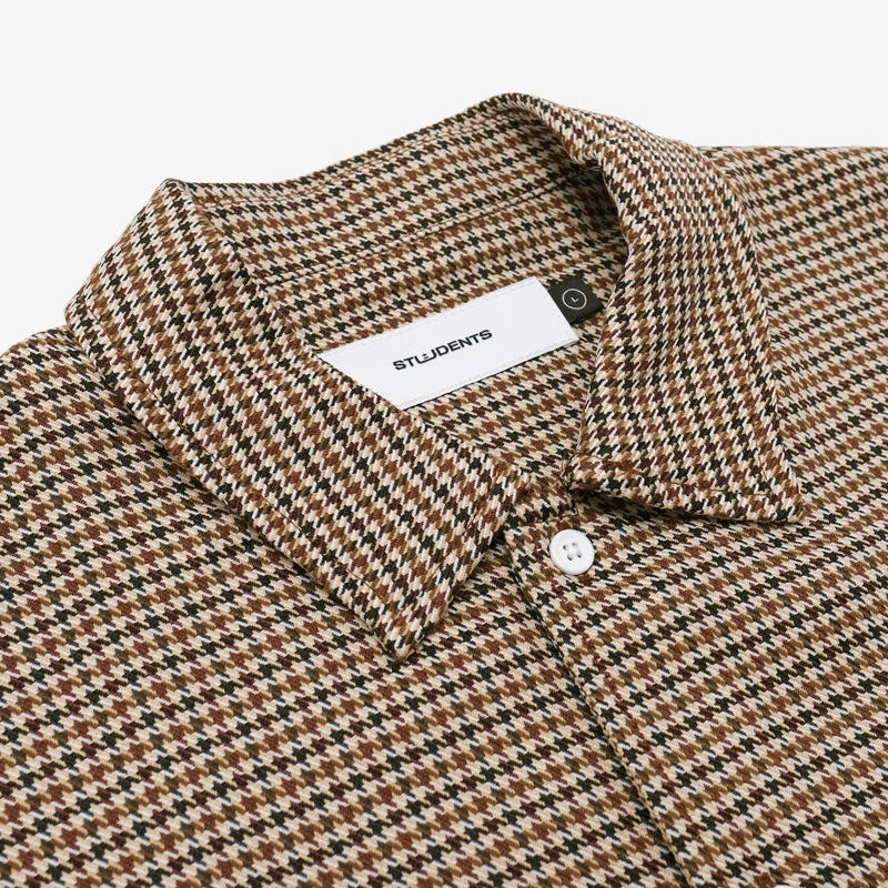 Houndstooth patterned shirt with a visible brand label on a white background