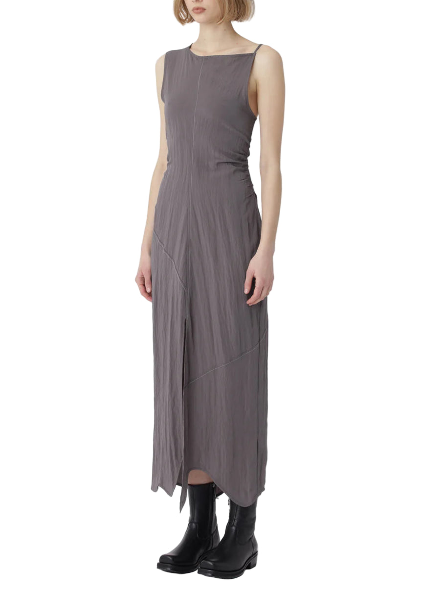 Woman wearing a gray sleeveless dress on a white background