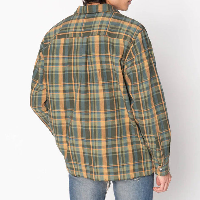 Person wearing a green and orange plaid shirt on a white background