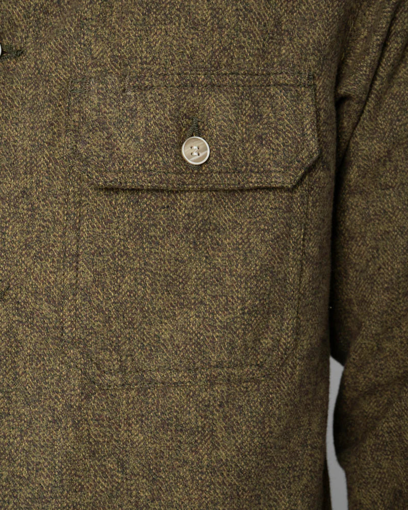 Brown textured shirt with a button on a white background