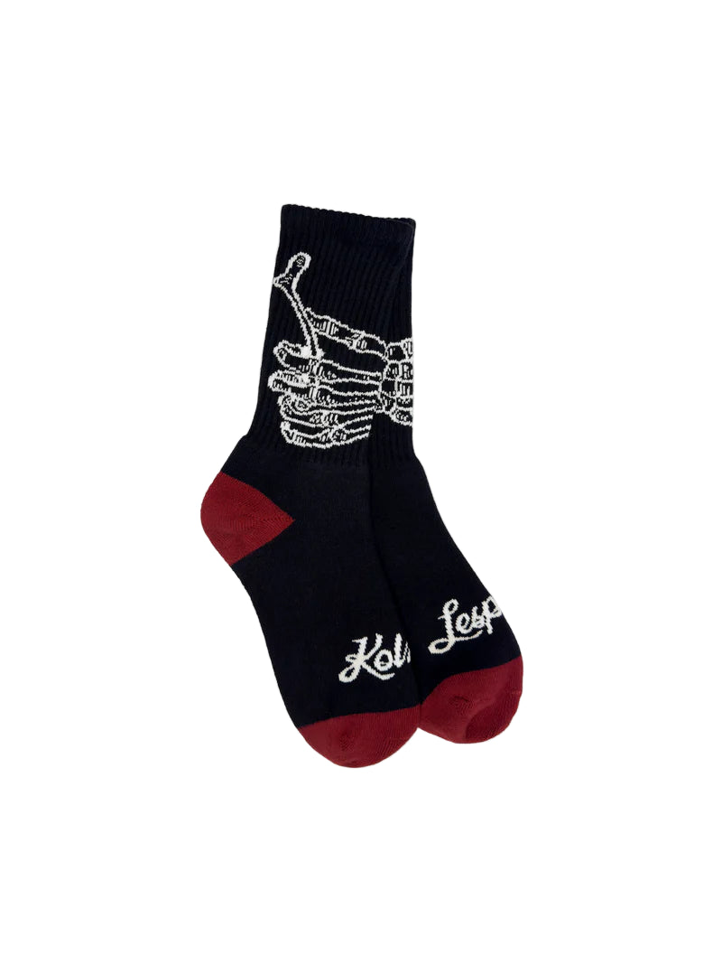 Black sock with skeleton hand design and text on a white background