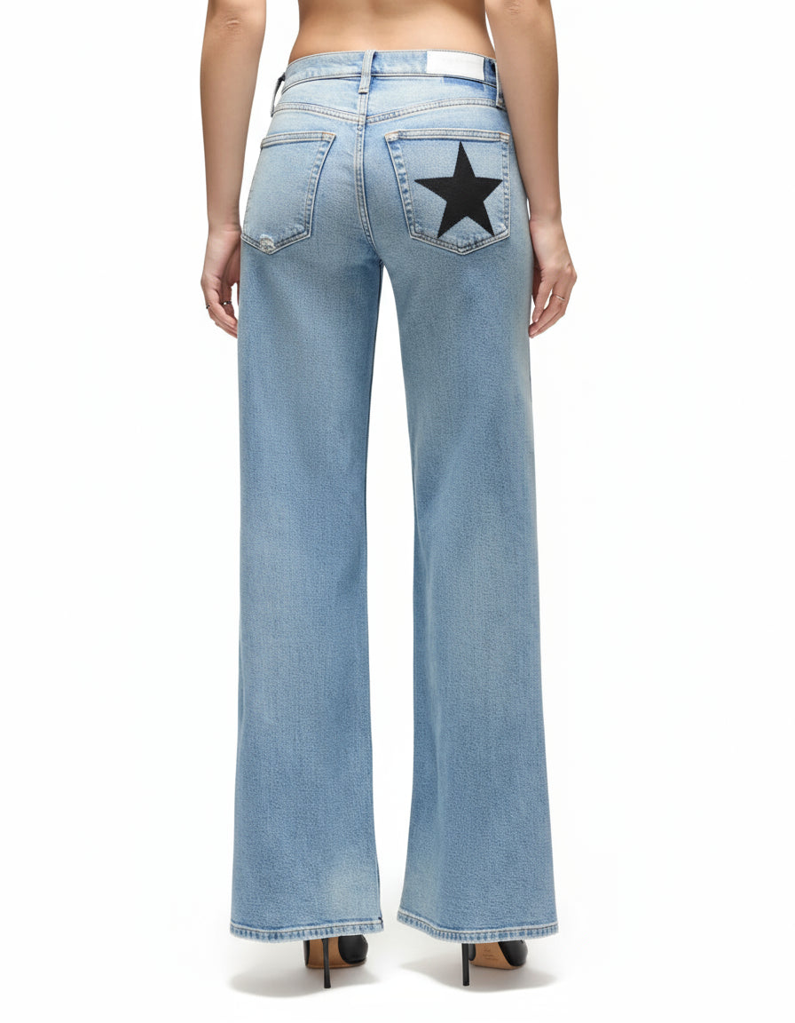 Light blue jeans with a star patch on a white background