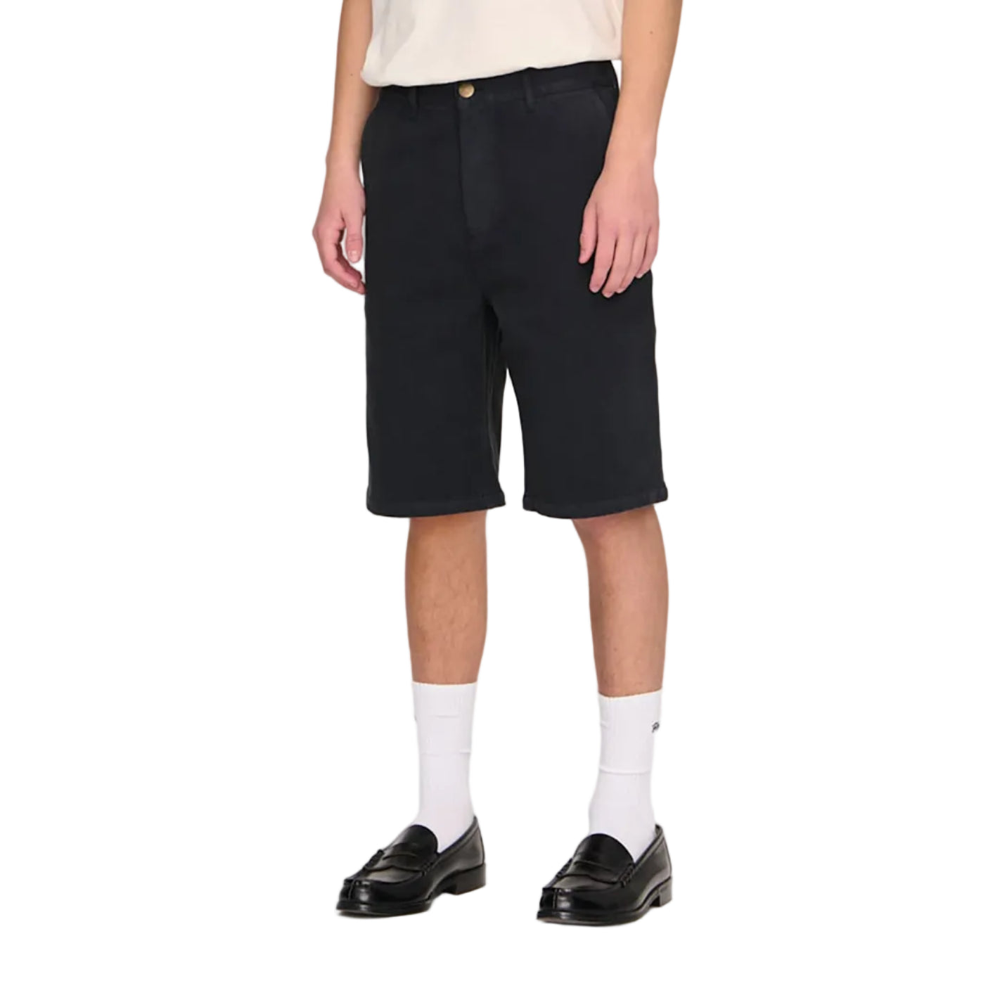 Person wearing a beige t-shirt and black shorts on a white background