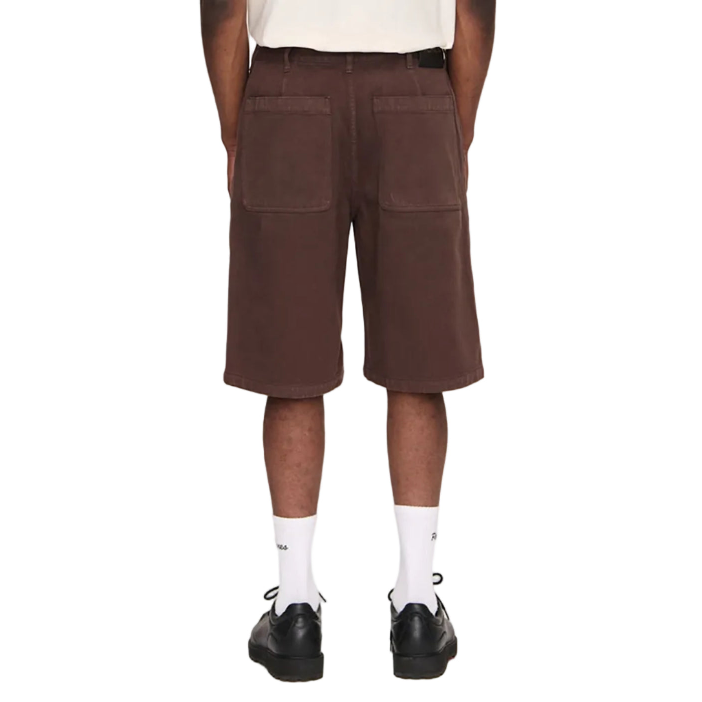 Person wearing brown shorts and a white t-shirt on a plain background