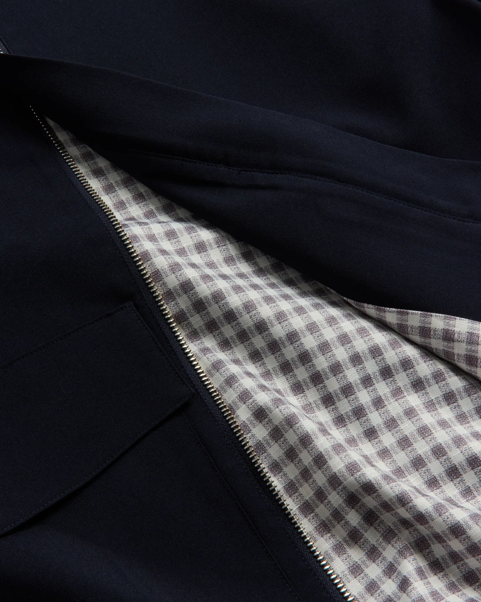 Close-up of dark fabric with a checkered pattern