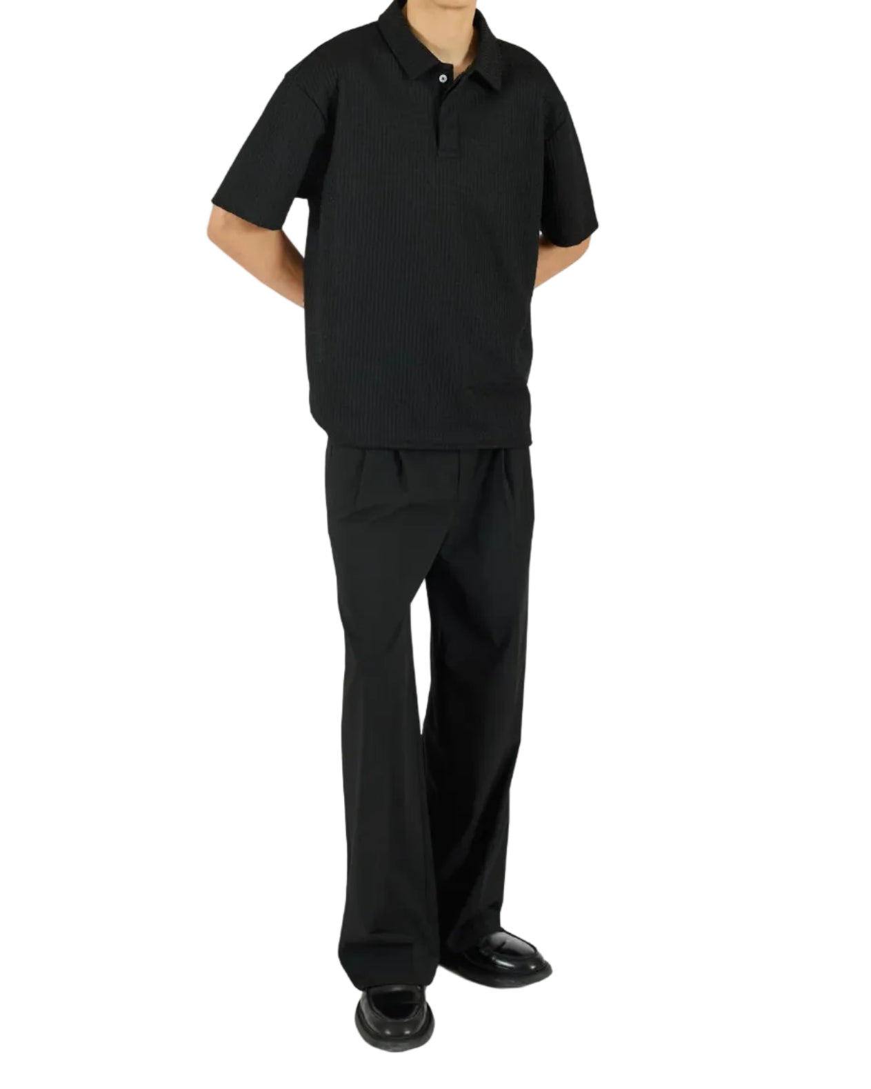 Person wearing a black outfit on a white background