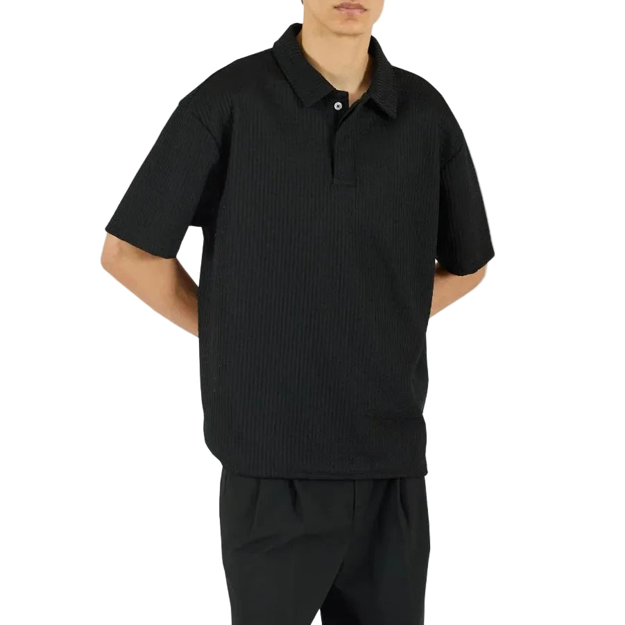 Person wearing a black outfit on a white background