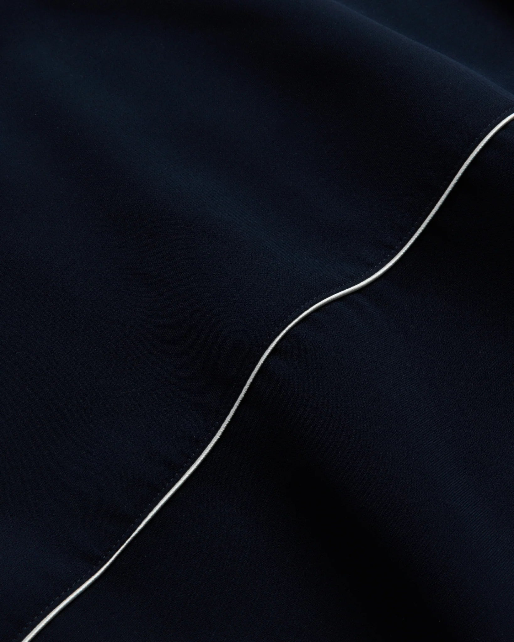 Close-up of a dark fabric with a white line running through it