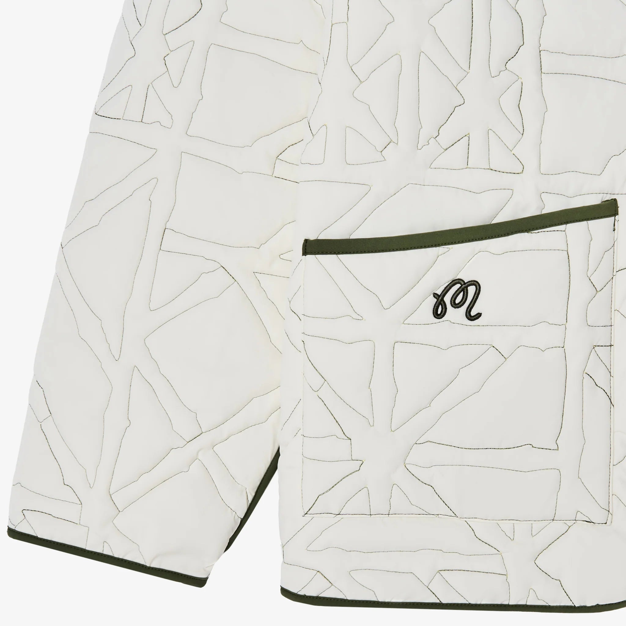 Close-up of a white jacket with geometric pattern and green trim on a white background