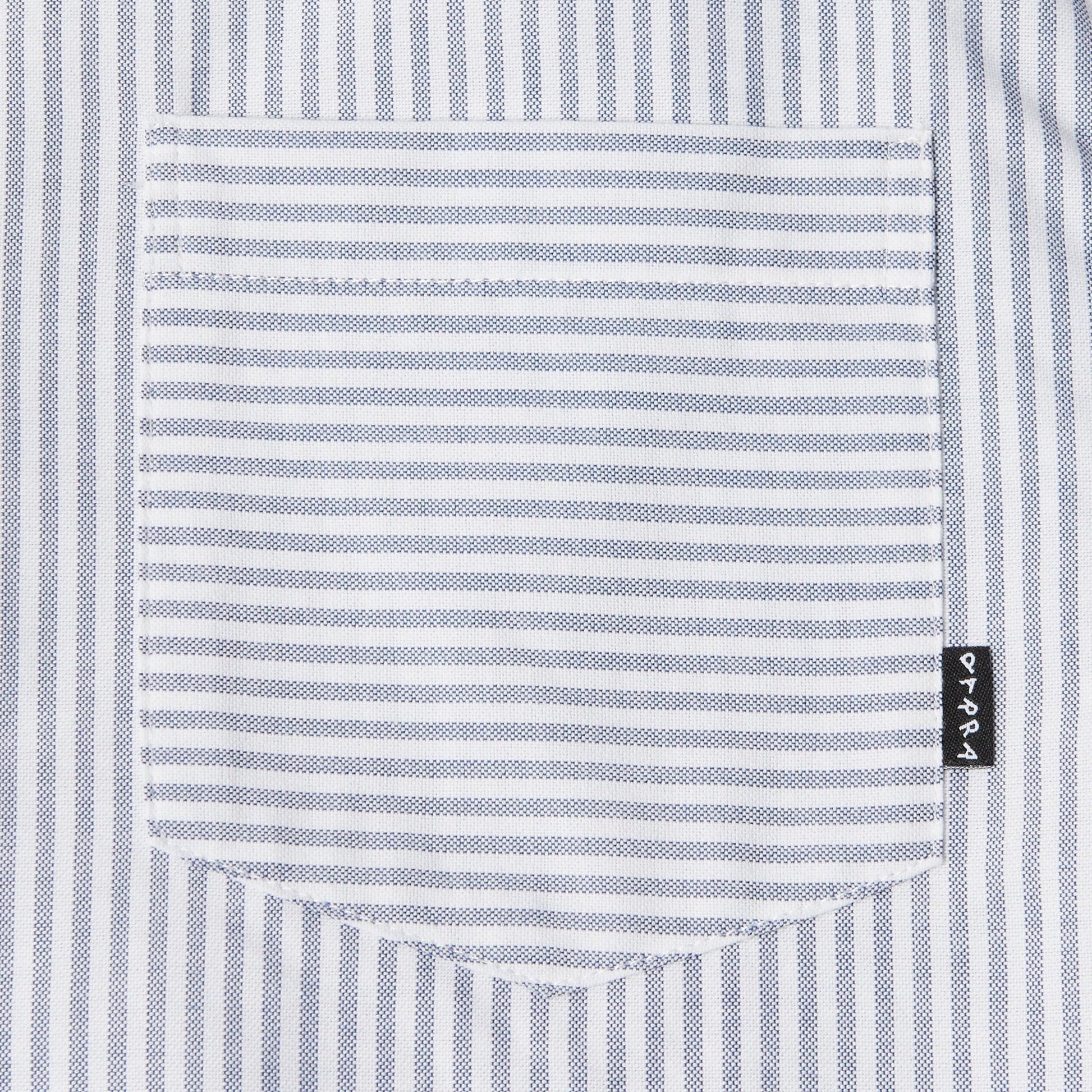 Close-up of a striped shirt pocket with a brand label.