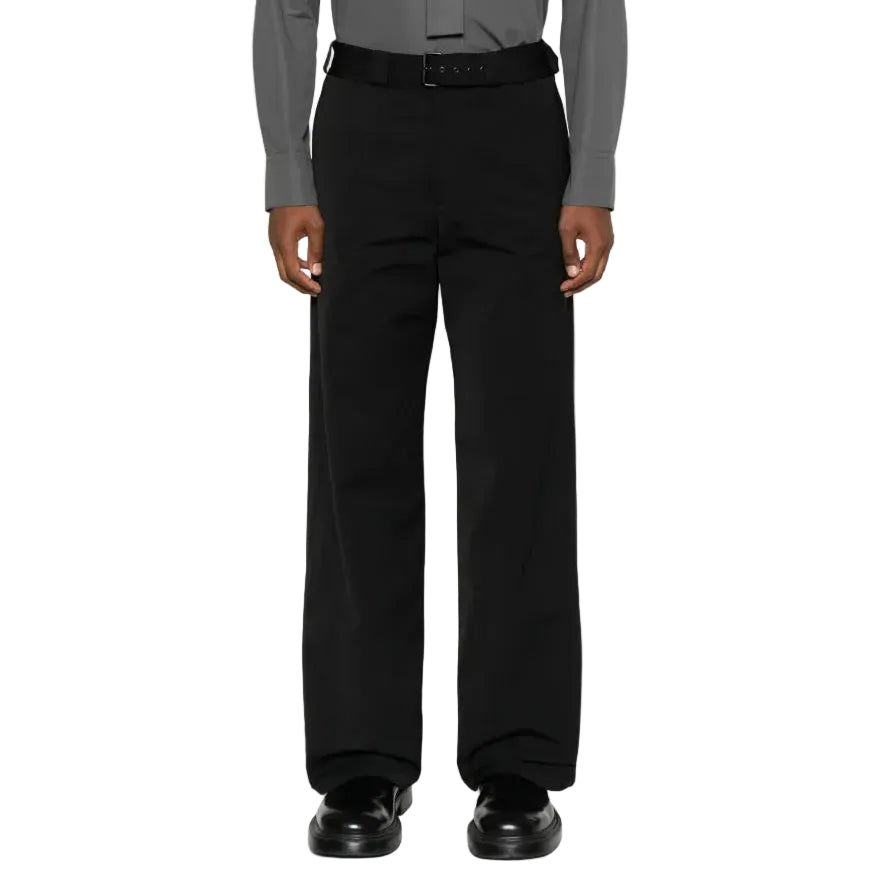 Person wearing a gray dress shirt and black pants on a white background