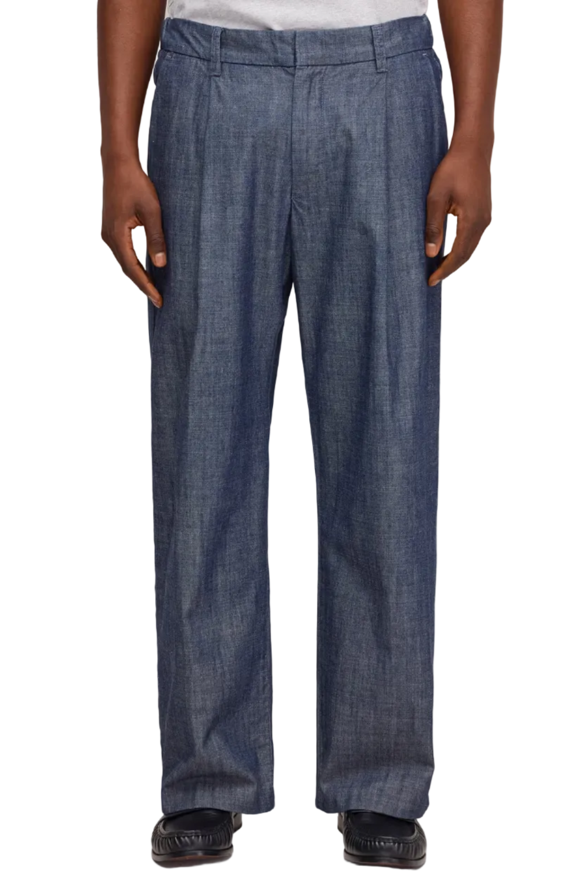 Person wearing blue jeans on a plain background