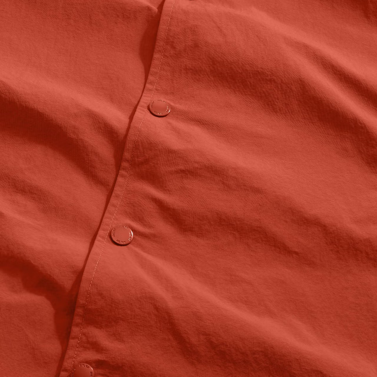 Close-up of a red shirt with buttons