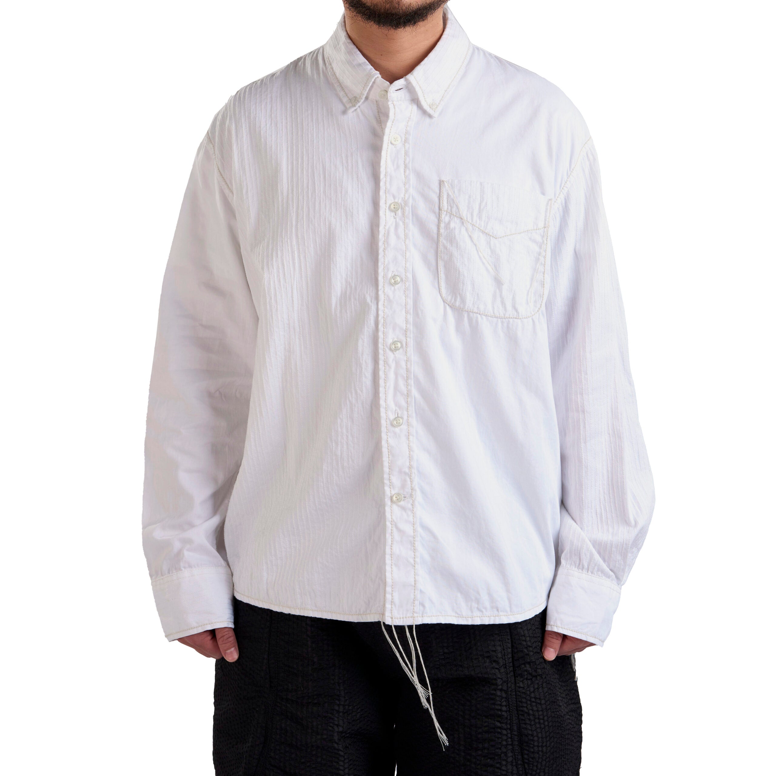 White button-up shirt worn by a person on a white background