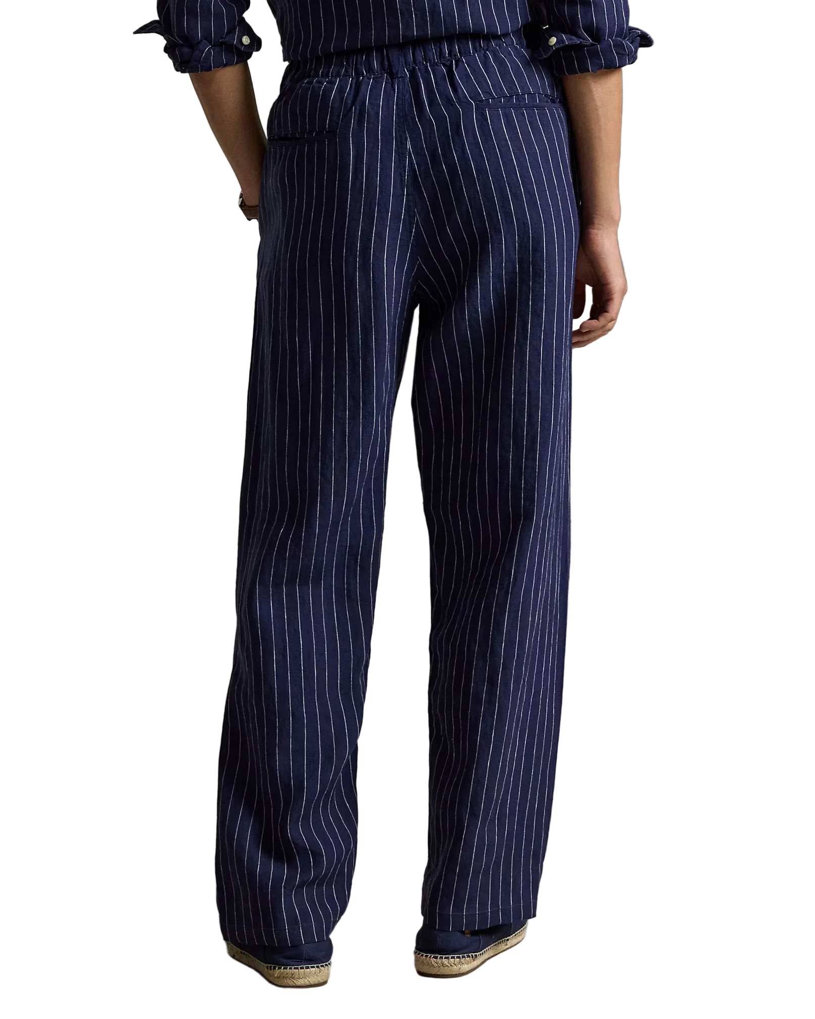 Navy pinstripe pants worn by a person on a neutral background
