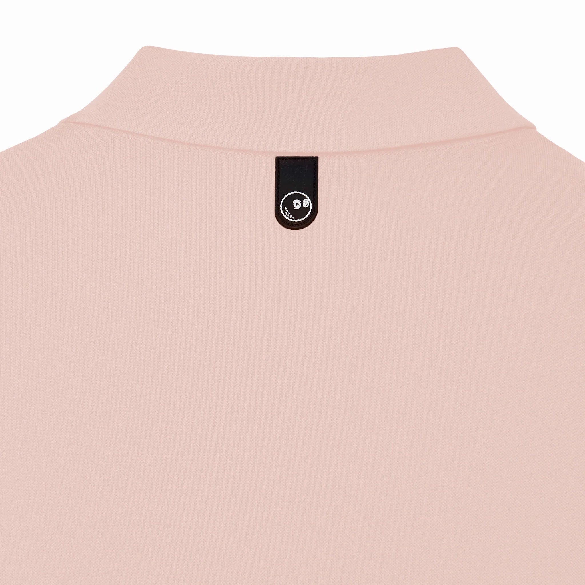 Close-up of the back of a pink polo shirt with a logo at the collar on a white background