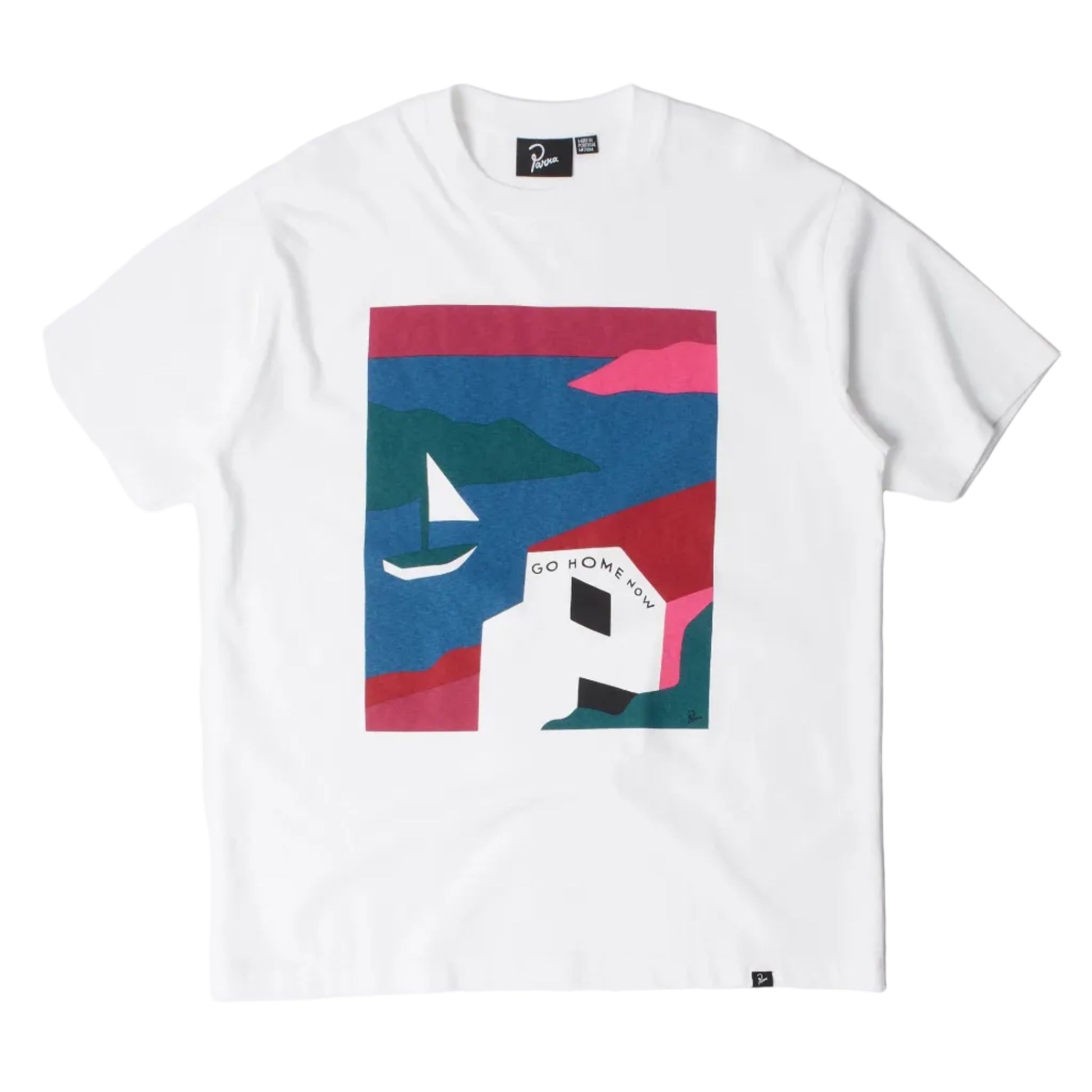 A white short-sleeve crewneck t-shirt featuring a colorful graphic print on the front. The graphic is a geometric, abstract landscape design with pink, blue, and teal shapes, including a small white sailboat and the text 'GO HOME NOW'.