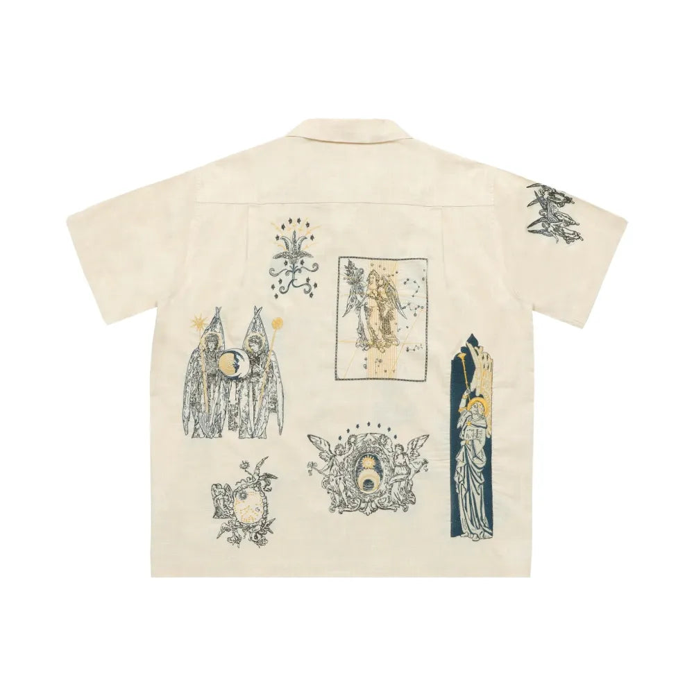 Beige shirt with black graphic designs on a white background