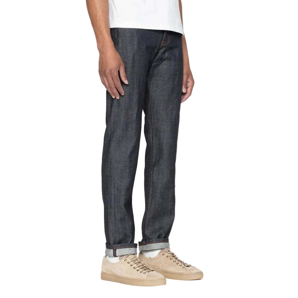 Person wearing dark blue jeans on a white background