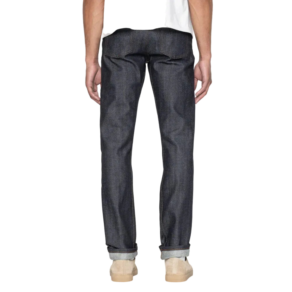 Person wearing dark blue jeans on a white background