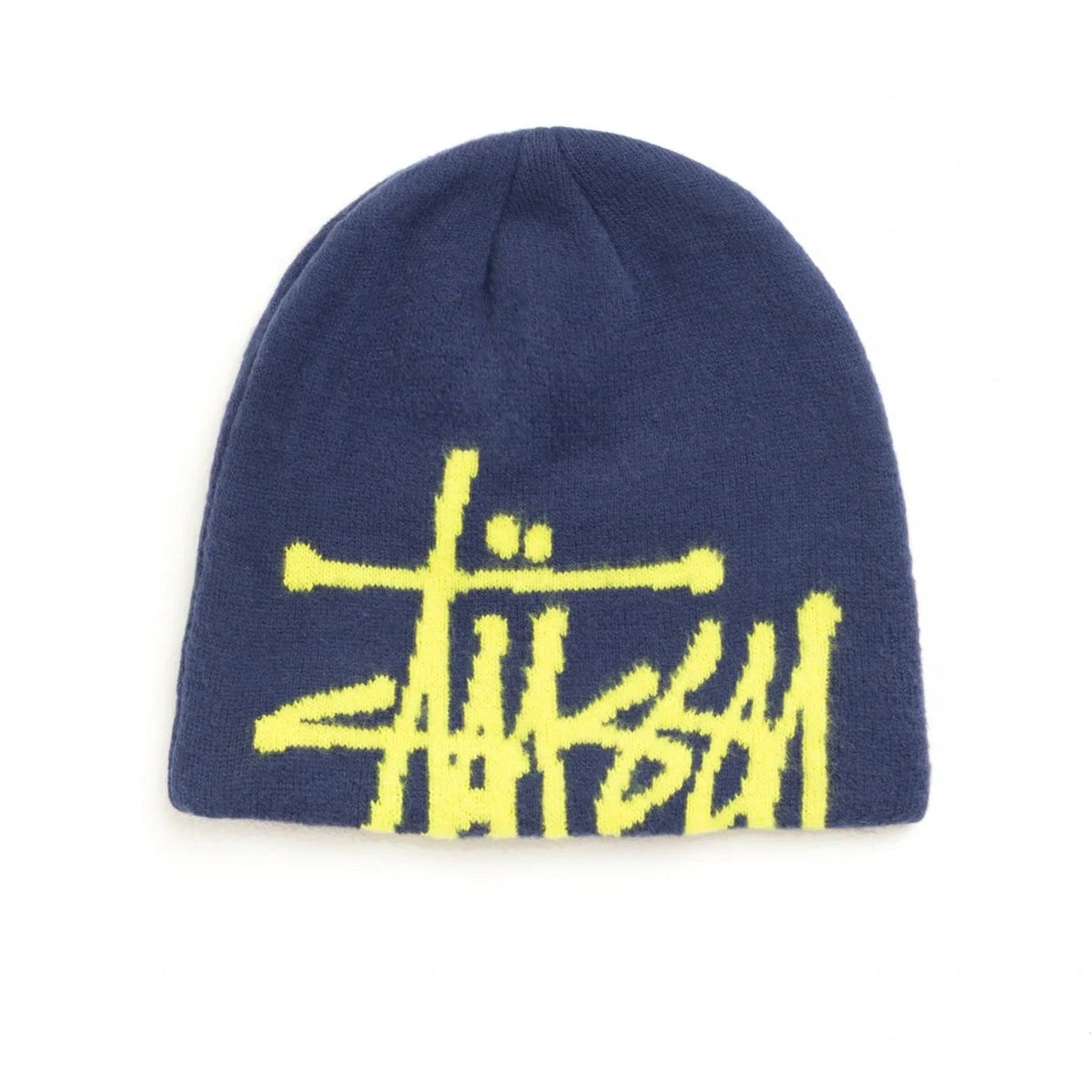 A navy blue knit beanie featuring a bright yellow embroidered Stüssy logo across the front, displayed against a solid white background.