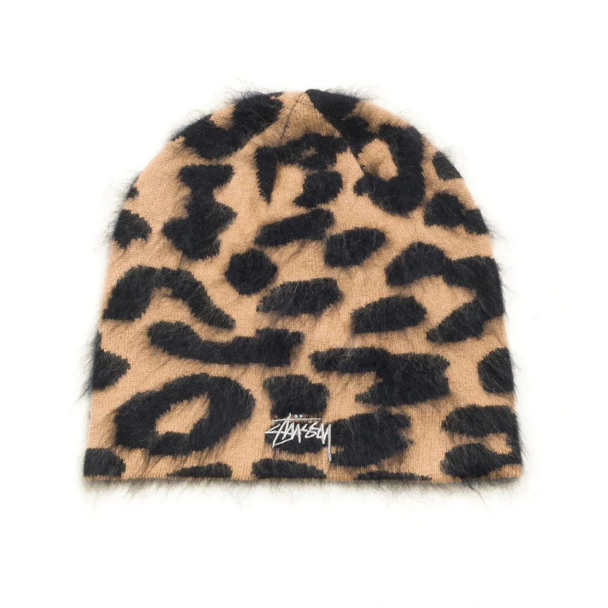 A fuzzy knit beanie hat featuring a leopard print pattern in tan and black, with a small white Stussy logo embroidered on the front cuff, set against a plain white background.