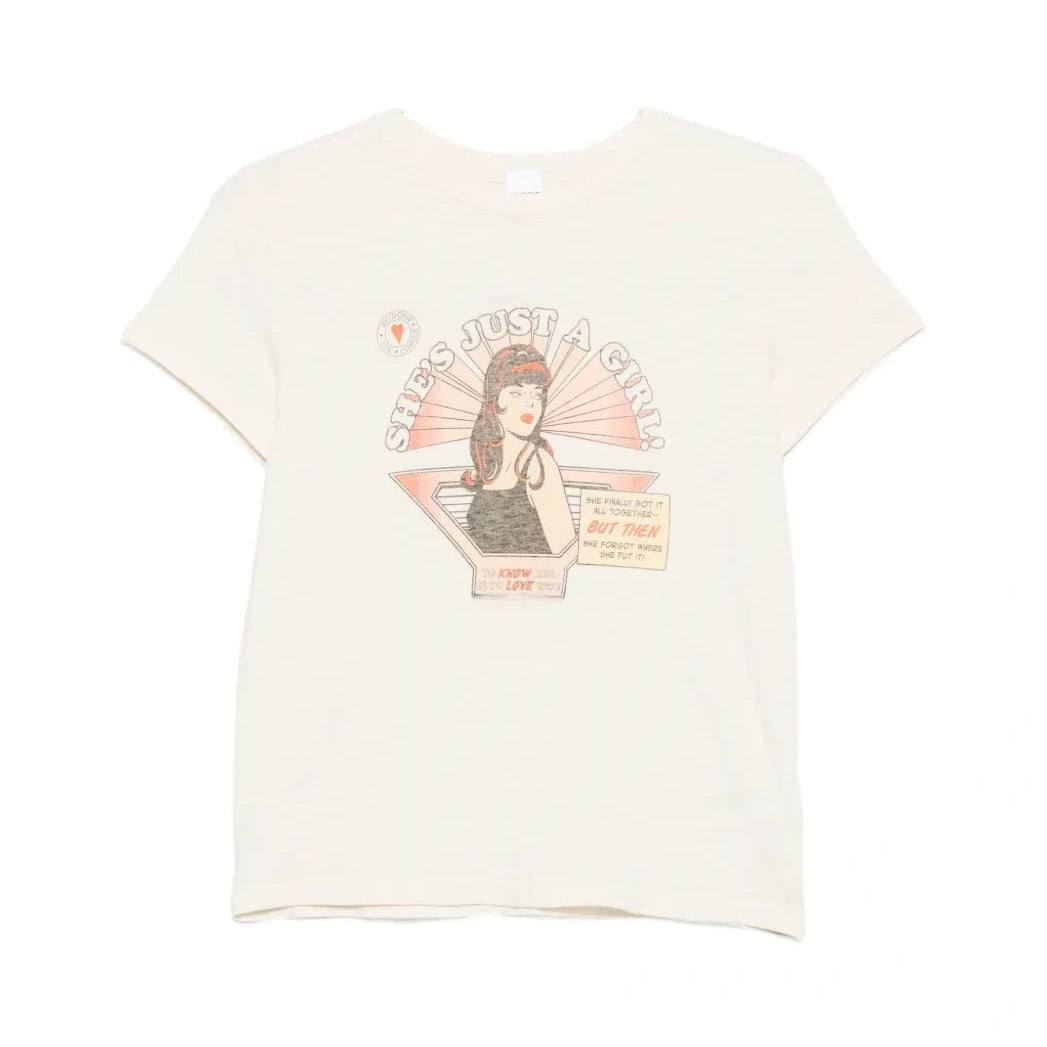 RE/DONE Classic Tee Just A Girl laid flat. A cream crewneck T-shirt with a retro comic graphic of a woman under the words “She’s Just A Girl!”