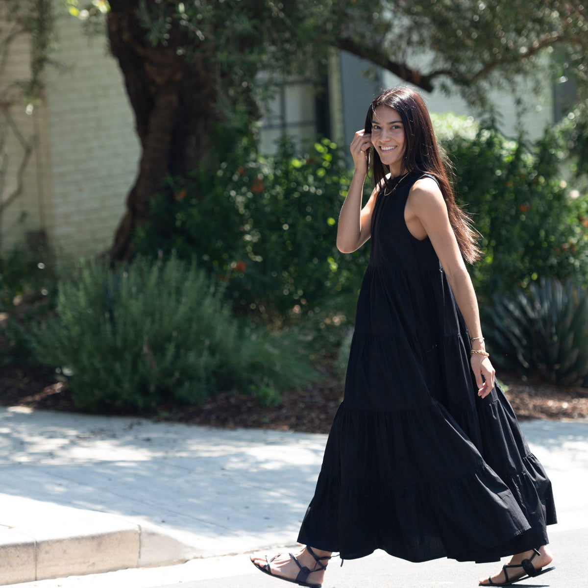 Sara maxi dress in solid black, full-length view of woman walking outdoors