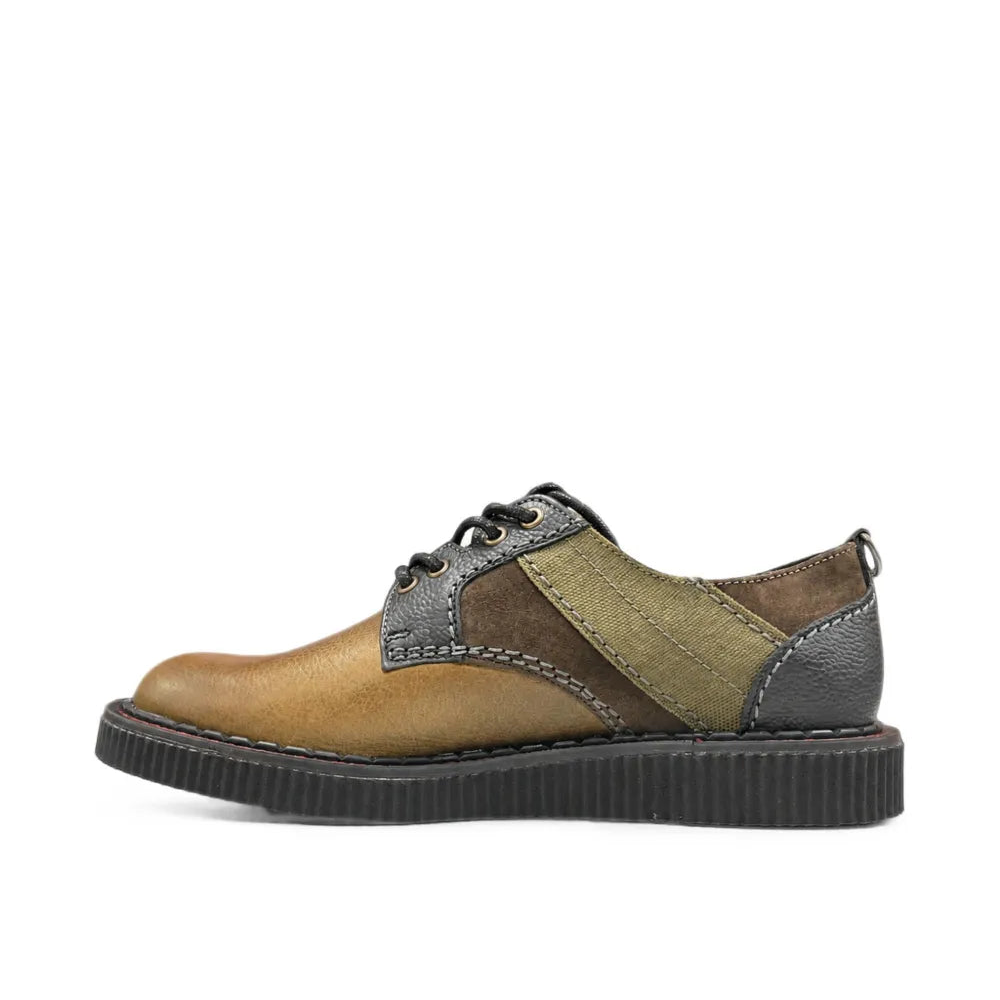 A low-top lace-up shoe with a color-blocked design featuring a tan leather toe, olive green suede panels, dark brown leather sections, and a black sole, shown against a plain white background.