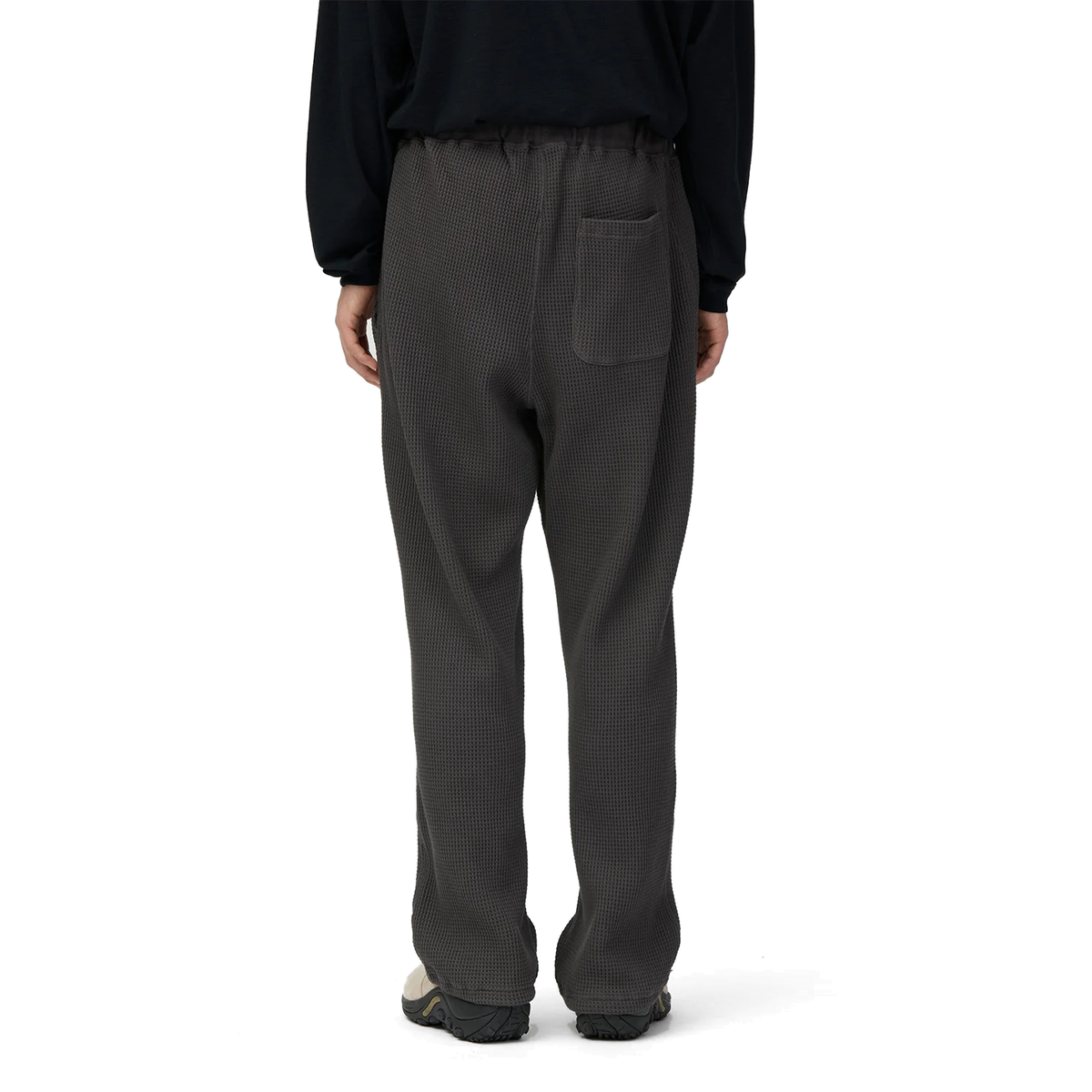Back view of a model wearing charcoal Snow Peak Heavyweight Waffle Pants, showing the elastic waist, single back patch pocket and straight legs.