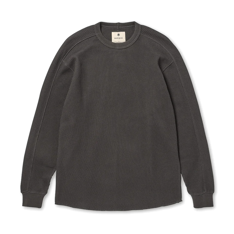Front view of a charcoal Snow Peak Heavyweight Waffle Pullover laid flat on white, showing the waffle-knit texture, crewneck, ribbed cuffs and raw-edge rounded hem.