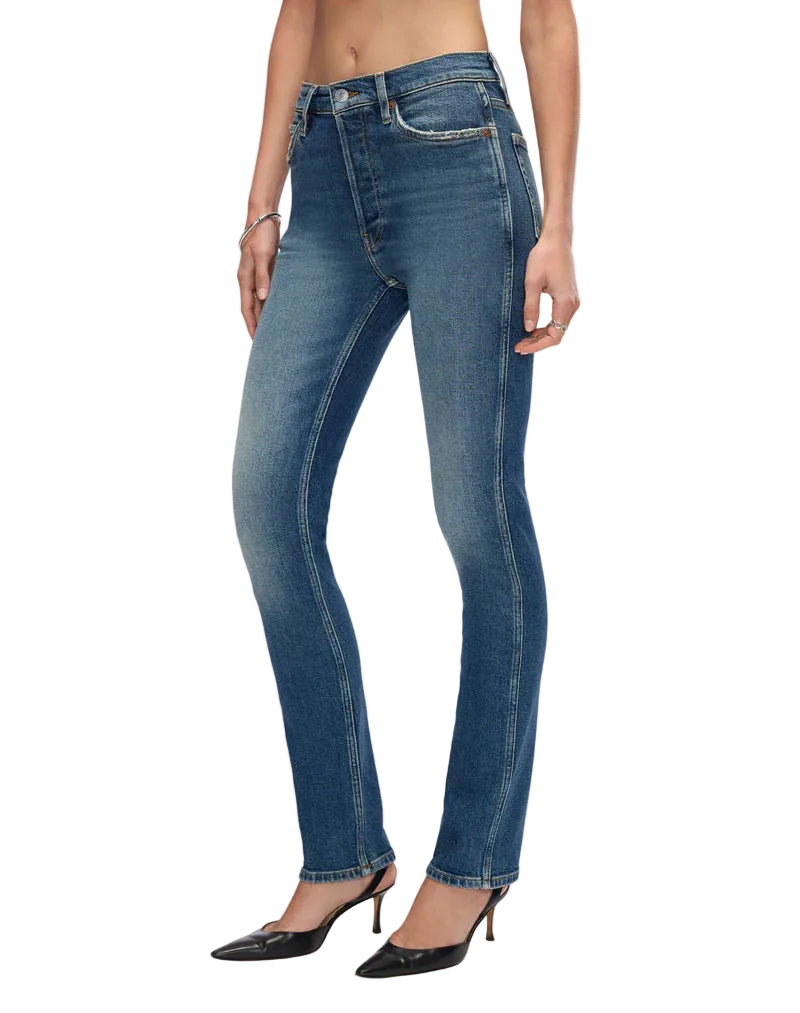 Blue jeans worn by a person on a white background