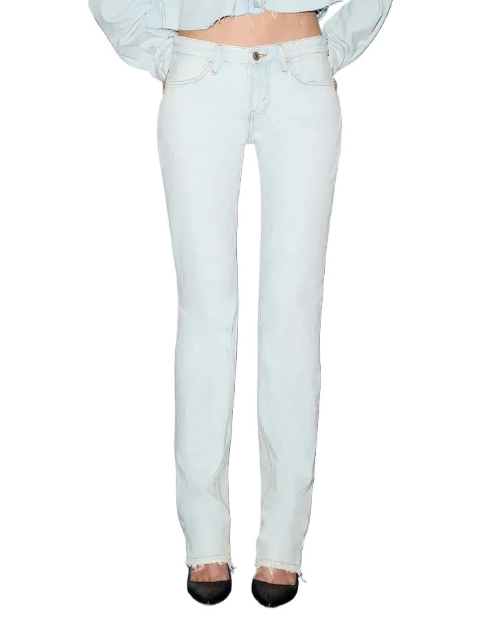 Woman wearing a light blue denim jacket and jeans on a white background