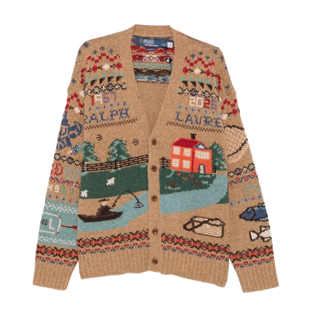 Polo Ralph Lauren Scenic Wool Cardigan laid flat. A camel V-neck cardigan knit with a countryside scene of a red farmhouse, trees, sheep and a fisherman in a boat, with Fair Isle bands and “Ralph Lauren” lettering.