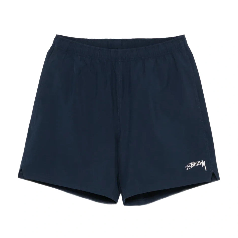 Front view of the Stüssy Sport Short in navy laid flat. Navy shorts with an elastic waist, split side hems and a cream Stüssy script logo on the leg.