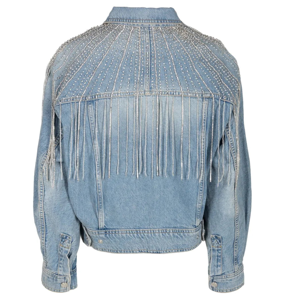 A light blue denim jacket shown from the back, featuring fringe detailing across the upper back and shoulders, and silver rhinestone embellishments on the shoulders and upper back.
