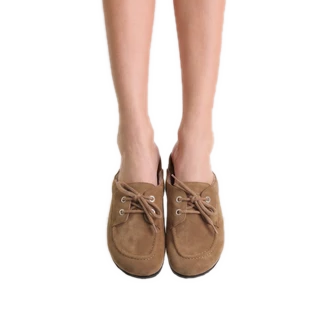 Front view of bare legs wearing taupe ROAM Moc Loafers with tied laces, showing the rounded moccasin toe and the slip-on fit.