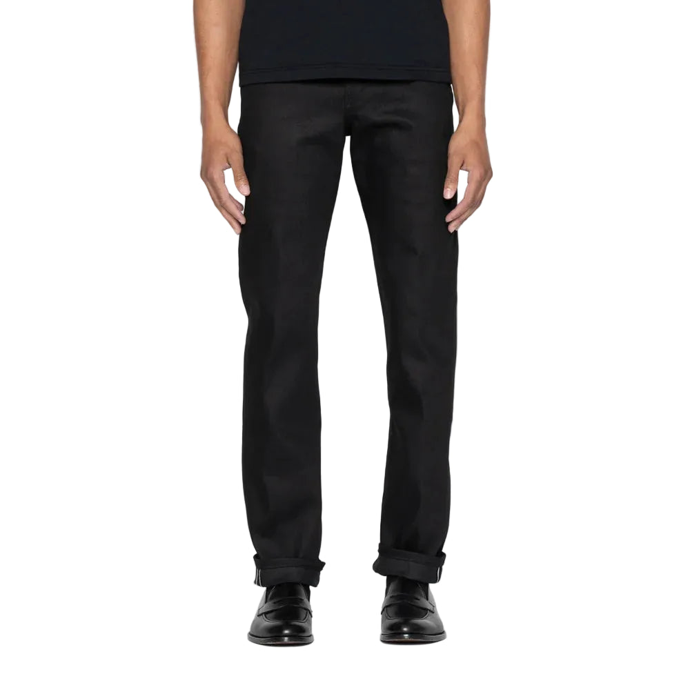 Peron wearing black jeans on a white background