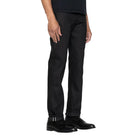 Peron wearing black jeans on a white background