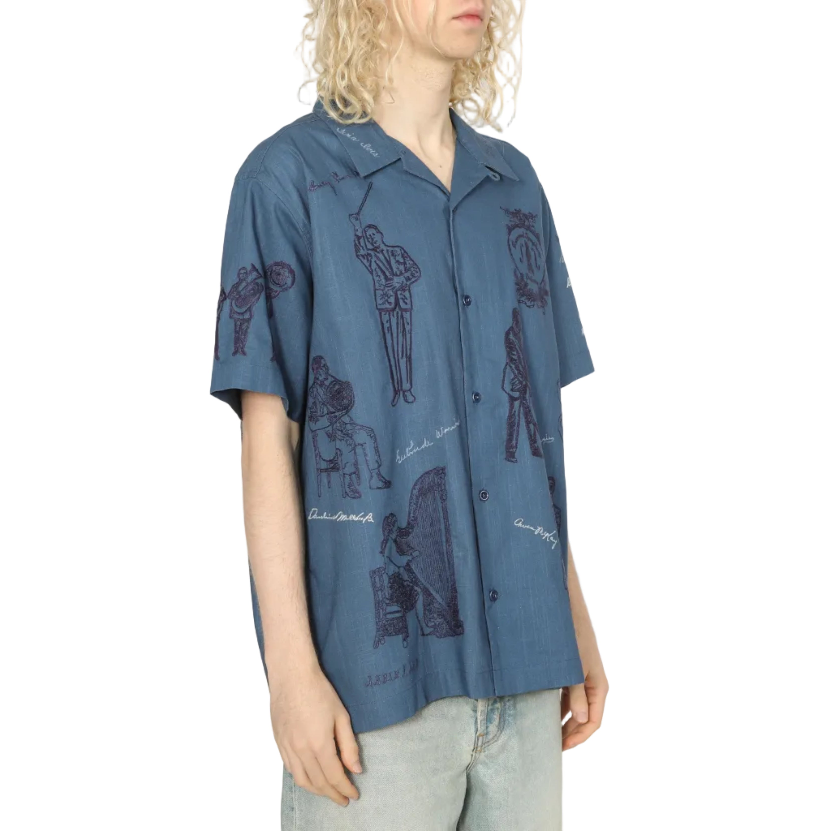 Person wearing a blue patterned shirt against a white background