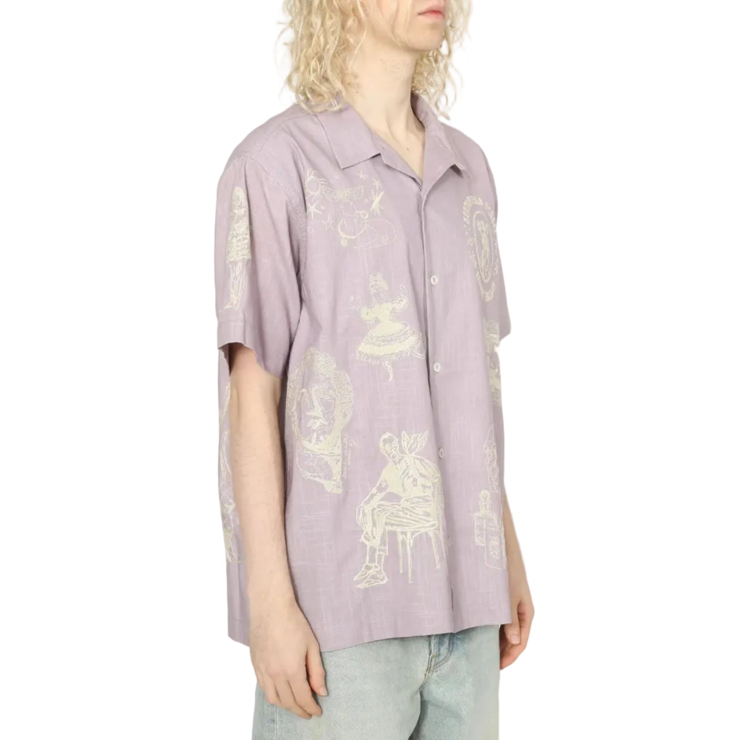 Person wearing a light purple shirt with graphic designs on a white background
