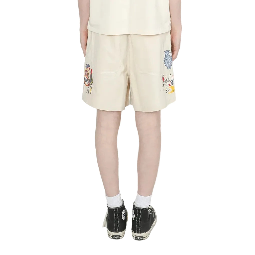 Person wearing a light-colored outfit with shorts and a t-shirt on a white background