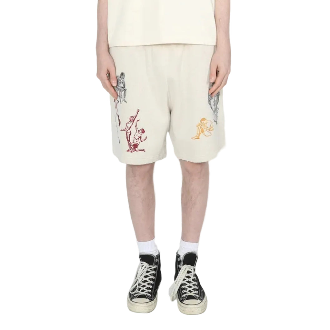 person wearing light grey shorts with embroidery designs on a white background