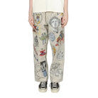 Person wearing a white t-shirt and patterned pants on a white background