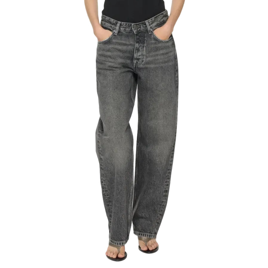 Person wearing black tank top and gray high-waisted jeans on a white background