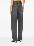 Person wearing high-waisted gray jeans on a white background